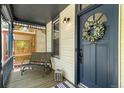 Cozy front porch with seating, adorned with a wreath on the front door at 300 E Cleveland St, Lafayette, CO 80026