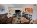 Inviting living room with a fireplace, hardwood floors, open to a kitchen with barstool seating at 460 S Marion Pkwy # 251, Denver, CO 80209