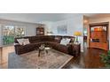 Spacious living room boasts hardwood floors, a cozy sectional sofa, and access to an outdoor balcony at 460 S Marion Pkwy # 251, Denver, CO 80209
