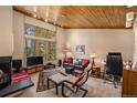Comfortable living room featuring large windows, a cozy fireplace, and a workspace at 877 Airport Rd # 19, Breckenridge, CO 80424