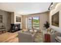 Comfortable living room with a fireplace and sliding glass door to outdoor scenery at 877 Airport Rd # 19, Breckenridge, CO 80424