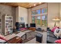 Living room with fireplace, large windows showcasing mountain views and built-in shelving at 877 Airport Rd # 19, Breckenridge, CO 80424