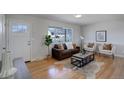 Inviting living room featuring stylish decor, hardwood floors, and natural light from a large window at 230 W 78Th Pl, Denver, CO 80221