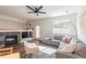 Bright living room with a cozy fireplace, stylish seating, and large windows at 4100 Albion St # 205, Denver, CO 80216