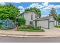 Two-story home with a detached garage and established landscaping at 1080 Tantra Park Cir, Boulder, CO 80305