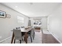 Bright dining room with wood floors, neutral paint and large windows at 962 Uvalda St, Aurora, CO 80011