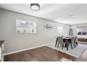 Bright dining room with wood floors, neutral paint and large windows at 962 Uvalda St, Aurora, CO 80011