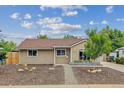 Charming single-story home featuring a well-maintained lawn and a welcoming entrance at 962 Uvalda St, Aurora, CO 80011