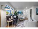 Bright living room boasting large windows, contemporary decor, wood flooring, and comfortable seating arrangements at 1360 S Forest Way, Denver, CO 80222