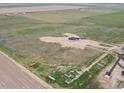 Expansive aerial view showcasing a modern home and surrounding acreage at 62101 E 32Nd Ct, Strasburg, CO 80136