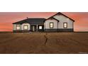 Striking exterior view of home showcasing modern design, contrasting colors, and desert landscape at 62101 E 32Nd Ct, Strasburg, CO 80136