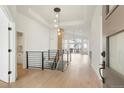 Contemporary entryway with open staircase and views to the living space beyond at 9640 Silver Hill Cir, Lone Tree, CO 80124