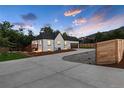Newly renovated home with a large driveway and a wood fence at 3360 Broadway St, Boulder, CO 80304