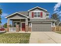 Beautiful two-story home with a brick-accented facade, a well-manicured lawn, and a welcoming front porch at 1488 N Stratton Ave, Castle Rock, CO 80104