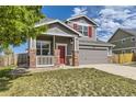 Lovely two-story home featuring a gray exterior, a front porch, and a well-kept lawn in a Gathering-friendly neighborhood at 1488 N Stratton Ave, Castle Rock, CO 80104