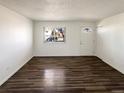 Bright living room featuring durable vinyl floors and a modern front door at 15850 E Utah Pl, Aurora, CO 80017