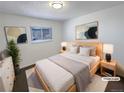 Light and bright main bedroom with large window and neutral decor at 15850 E Utah Pl, Aurora, CO 80017