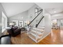 Bright living room with vaulted ceilings, hardwood floors, and a staircase at 8274 S Jackson St, Centennial, CO 80122