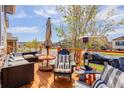 Relaxing outdoor deck featuring patio furniture, a heat lamp, and a view of the neighborhood at 18027 Telford Ave, Parker, CO 80134