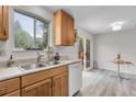 Bright kitchen with a stainless steel sink, dishwasher, and a sliding door that leads to a patio at 4580 W 109Th Ave, Westminster, CO 80031