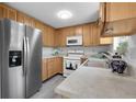 Well-maintained kitchen featuring wood cabinetry, stainless steel refrigerator, and modern appliances at 4580 W 109Th Ave, Westminster, CO 80031