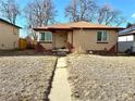 Charming brick ranch home features a large front yard at 3541 Eudora St, Denver, CO 80207