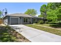 Charming single-story home with painted brick, attached garage, and well-maintained lawn at 971 Ursula St, Aurora, CO 80011