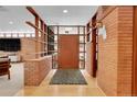 Mid-century modern entryway with brick walls and wood accents at 5030 Aspen Dr, Littleton, CO 80123