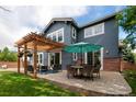 Spacious backyard patio with pergola, seating area, and umbrella at 3100 Rockbridge Dr, Highlands Ranch, CO 80129