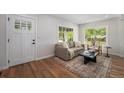Inviting living room with a large window, stylish furniture, and hardwood floors creating a cozy atmosphere at 1089 S Osceola St, Denver, CO 80219