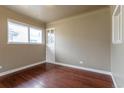 Cozy bedroom with hardwood floors, built-in shelving, and a large window at 3632 Leyden St, Denver, CO 80207