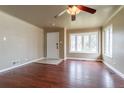 Bright living room with hardwood floors, ceiling fan, and a large bay window at 3632 Leyden St, Denver, CO 80207