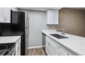 Well-lit kitchen with stainless steel appliances, white cabinets, and a modern sink at 447 S Memphis Way # 7, Aurora, CO 80017