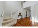 Bright entryway with hardwood floors, staircase, and view of the second level at 5017 Bella Vista Dr, Longmont, CO 80503