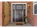 Elegant front door with sidelights and a welcoming 'home' doormat at 5017 Bella Vista Dr, Longmont, CO 80503
