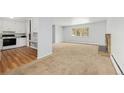 Open concept kitchen flowing into living room with fireplace at 387 Tucson St, Aurora, CO 80011
