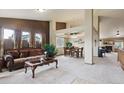 Open-concept living room and dining room with a fireplace and plush carpet at 4143 Eagle Ridge Way, Castle Rock, CO 80104