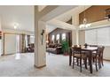 Open-concept living and dining area with neutral carpet, vaulted ceiling, and ample natural light at 4143 Eagle Ridge Way, Castle Rock, CO 80104