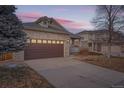 Brick home with a brown garage door and a spacious driveway at 20351 E Lasalle Pl, Aurora, CO 80013