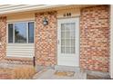 Close up of the front door, showing brickwork, front door and front window at 1188 S Troy St, Aurora, CO 80012