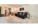 Living room with dark gray couch, TV, and dining area view at 1517 S Owens St # 7, Denver, CO 80232