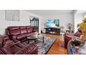 Comfortable living room features hardwood floors, a fireplace, and plush seating at 18982 E 46Th Ave, Denver, CO 80249