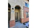 Front entrance to a townhome with brick accents and arched entry at 230 Poplar St # B, Denver, CO 80220