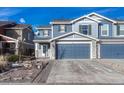 Two-story house with blue siding, stone accents, and a two-car garage at 5780 Raleigh Cir, Castle Rock, CO 80104