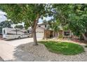 Two-story house with a large tree in front and RV parking at 3317 S Elkhart St, Aurora, CO 80014