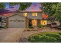 Attractive two-story home showcasing curb appeal at dusk at 3317 S Elkhart St, Aurora, CO 80014