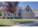 Beautiful two-story home with brick facade, three-car garage, manicured lawn, and inviting covered porch at 23500 Bent Oaks Way, Parker, CO 80138