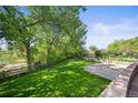 Spacious, well-maintained backyard with a basketball court, garden area, and mature trees at 6862 Independence Ct, Arvada, CO 80004