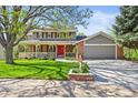 Charming home with a spacious porch, lush lawn, and attached garage, offering a blend of comfort and convenience at 6862 Independence Ct, Arvada, CO 80004