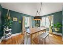 Cozy dining room featuring hardwood floors, two windows and a rustic chandelier at 1354 Tamarac St, Denver, CO 80220